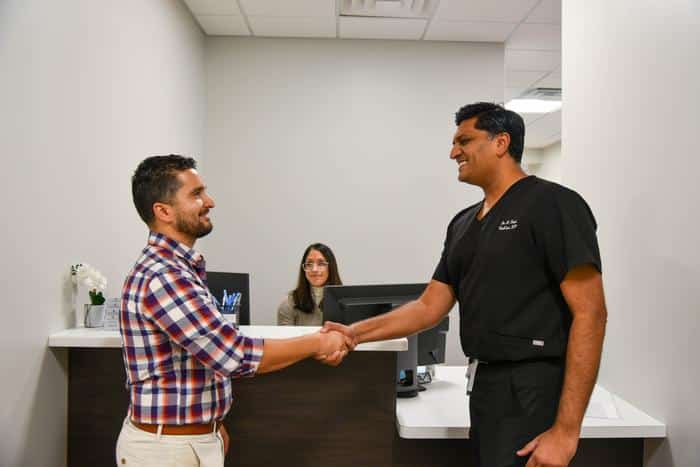 Dr. Shah and patient shaking hands