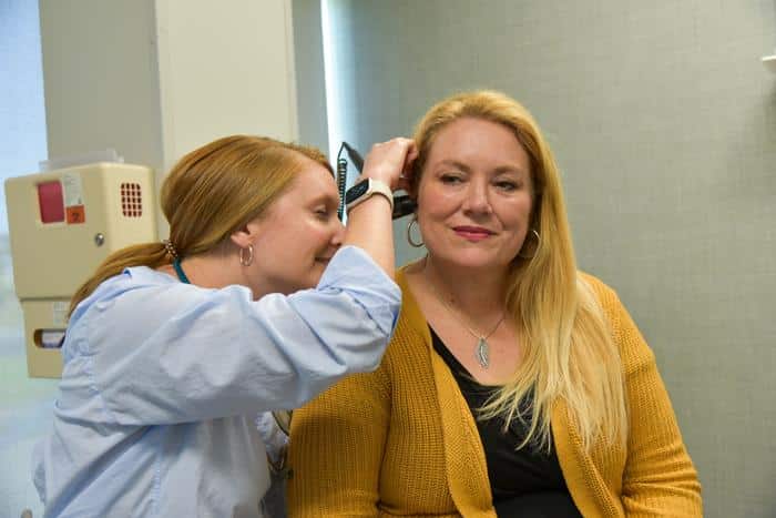 Team member examining patient for annual physical