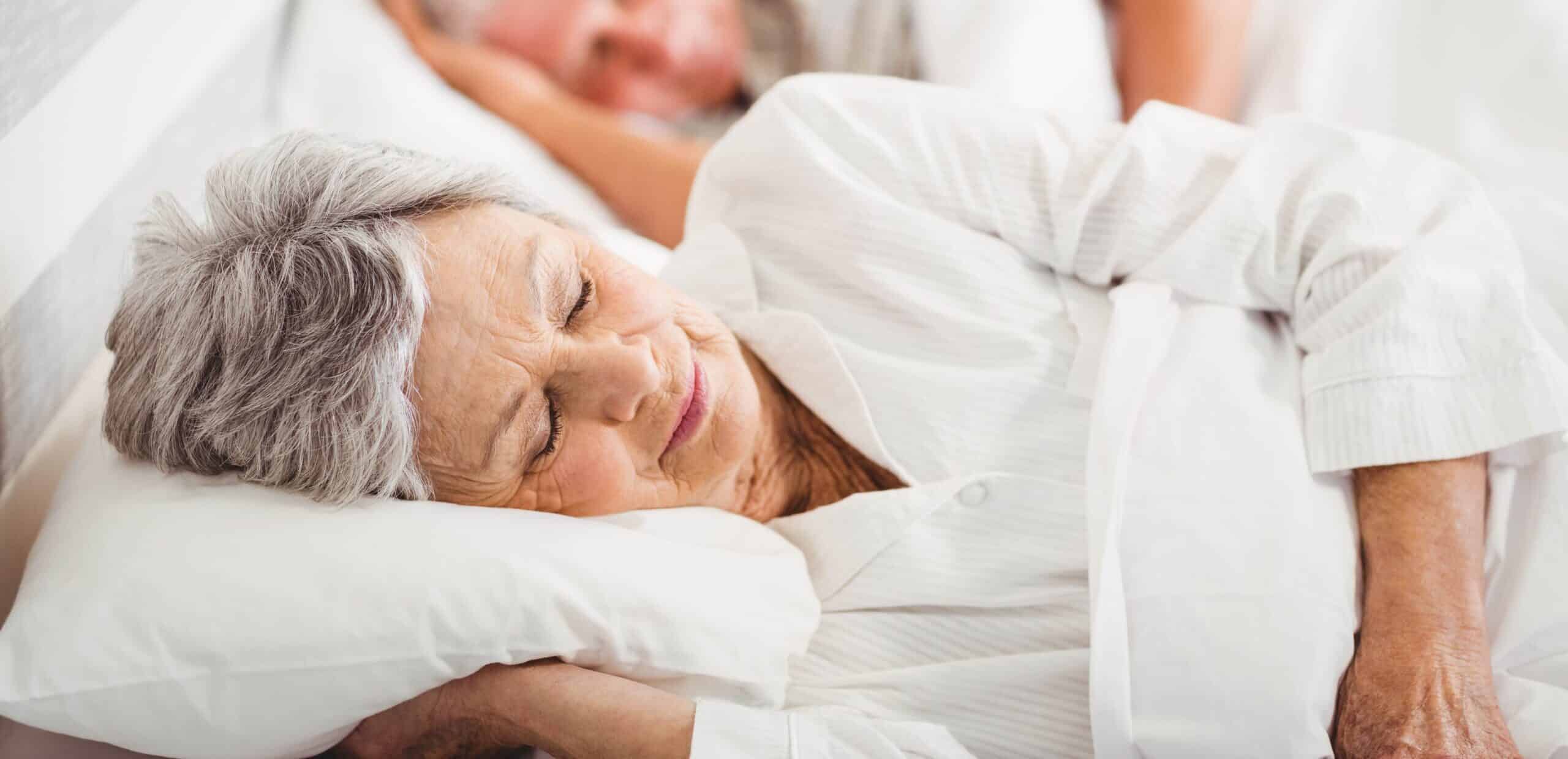 Senior couple sleeping on bed Sleep apnea treatment
